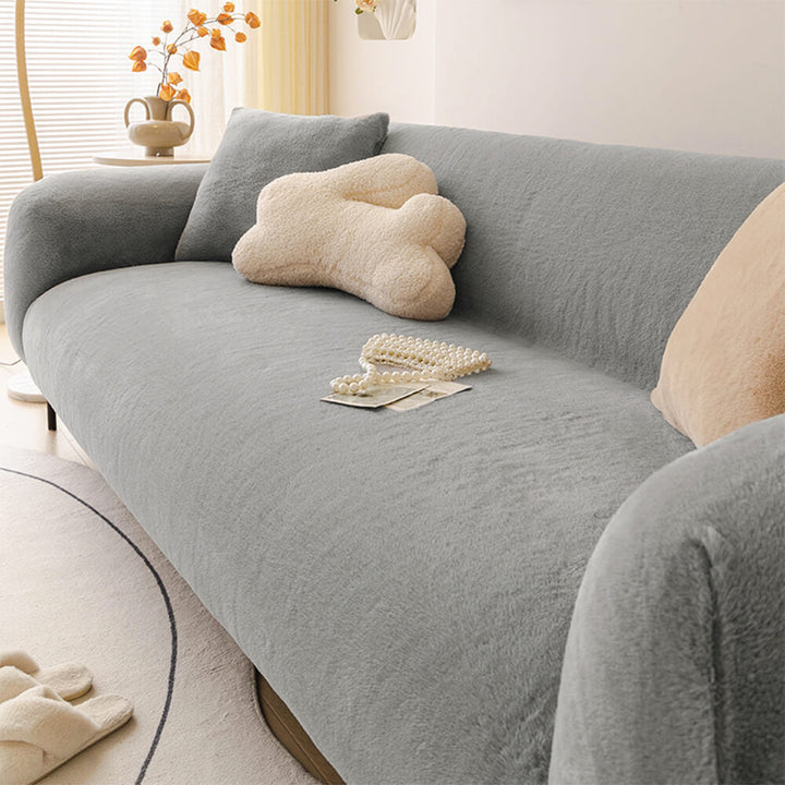 Elastic fit sofa slipcover made from plush, skin-friendly material, perfect for living room couch protection.