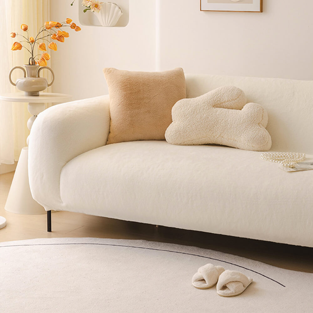 Detail of the stretchable fabric on a plush sofa cover, designed for full coverage and easy care.