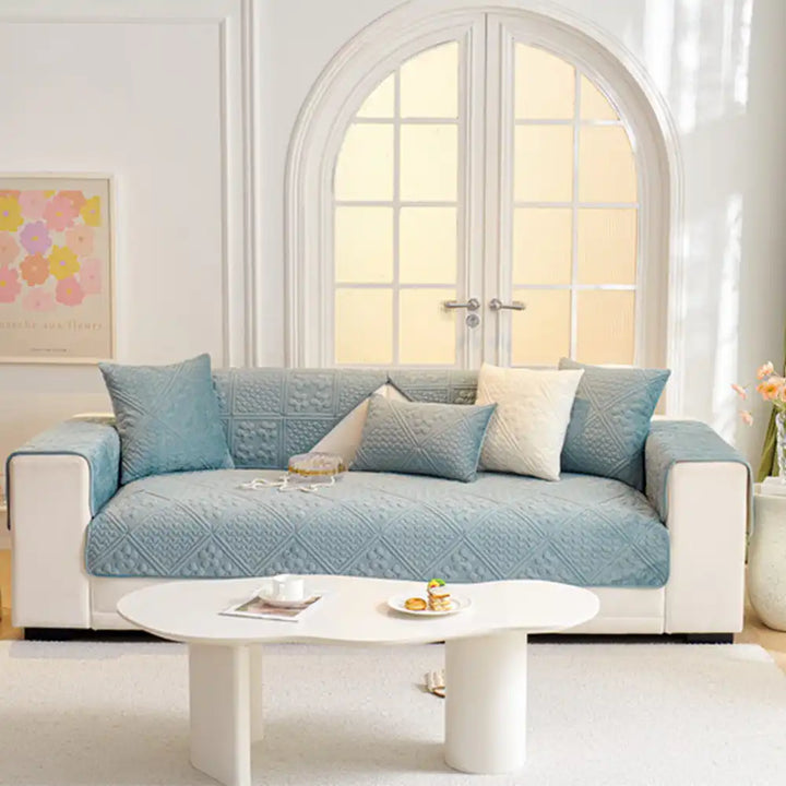 Full shot of a living room with an embossed geometric plush sofa protector, stylish furniture protection.