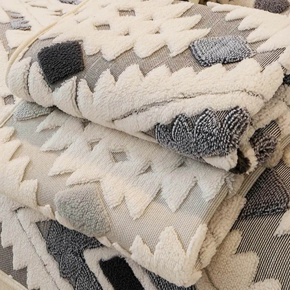 Detail of geometric design on a thick plush pet-friendly couch cover, non-slip backing.