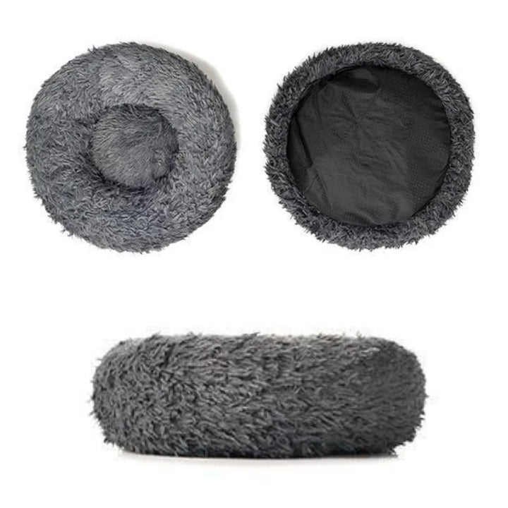 Fluffy pink calming pet bed, ideal for cats & small dogs, promotes deep, anxiety-free sleep.