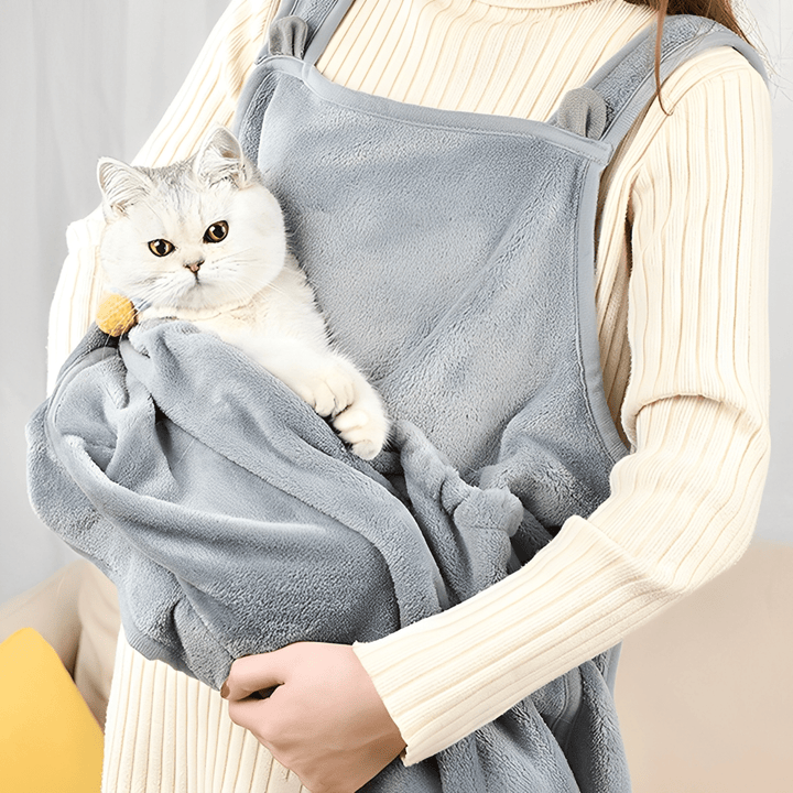 Hands-free plush cat carrier sling, black, worn by person for pet comfort and closeness
