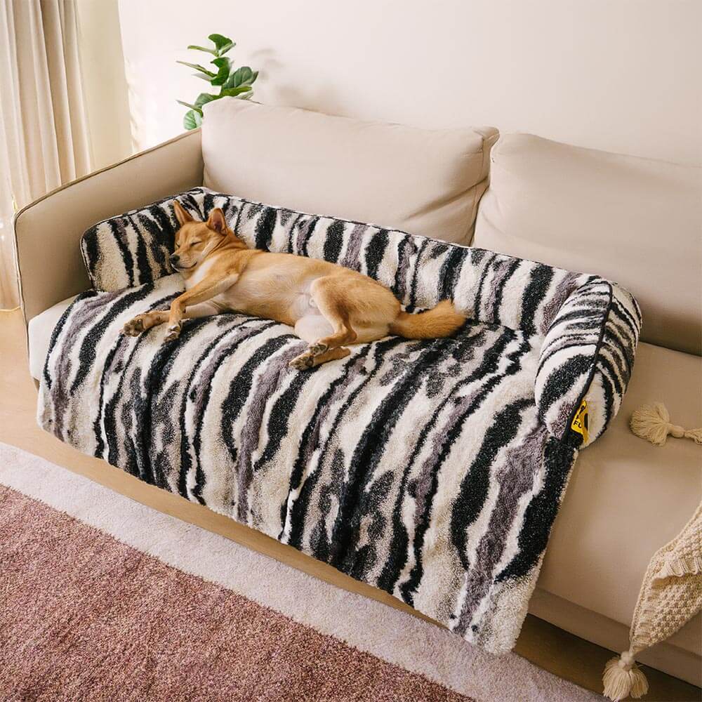 Beige plush dog mat acting as a sofa protector, enhancing home decor. Soft pet bed.