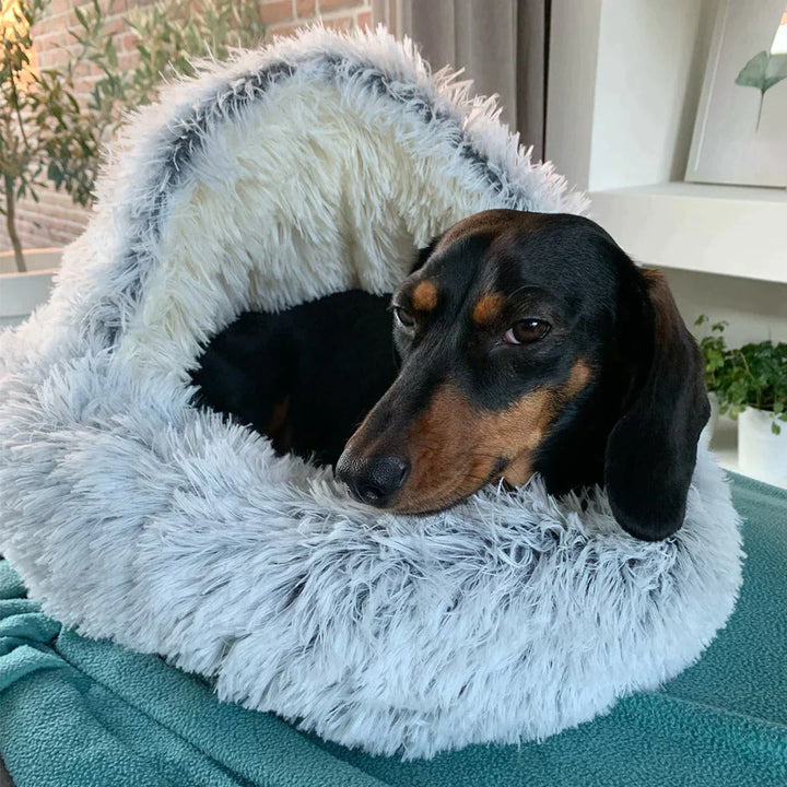 Plush grey faux fur calming pet bed for anxiety relief, suitable for dogs and cats, soft comfort.