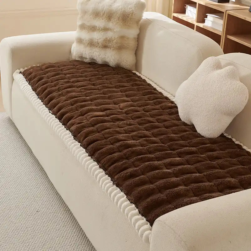 Beige fluffy sofa protector, comfortable and anti-slip for pet-friendly homes.