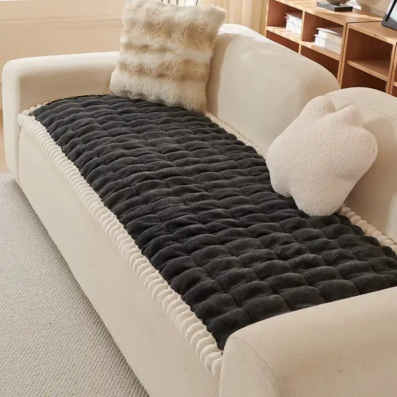 Fluffy blue sofa cover, soft texture, anti-slip backing, easy to clean.