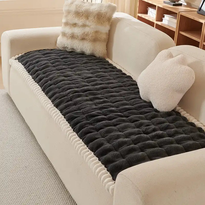Fluffy blue sofa cover, soft texture, anti-slip backing, easy to clean.