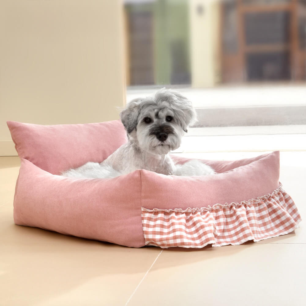 Unisex pet sofa bed in neutral tone with elevated ruffled edge, ideal for a comfortable dog or cat rest.