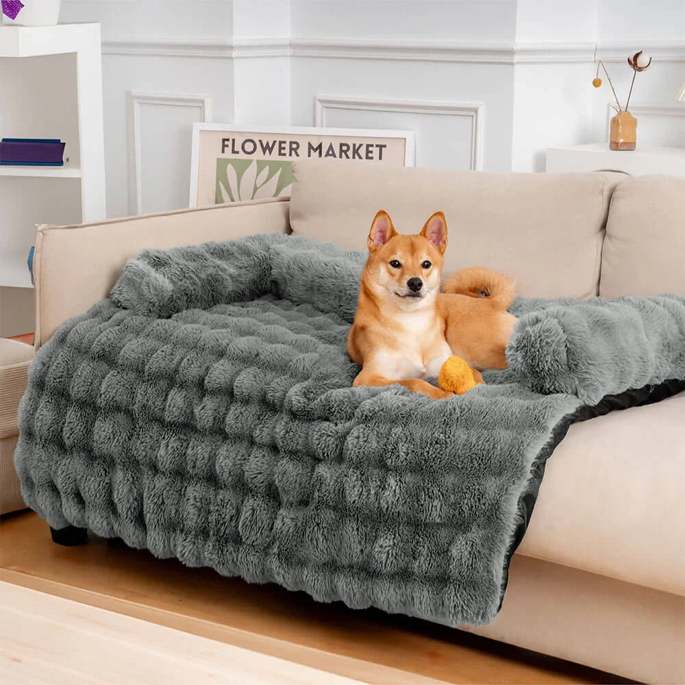 Dog comfortably sleeping on a grey pet sofa protector and calming dog bed mat, washable couch cover