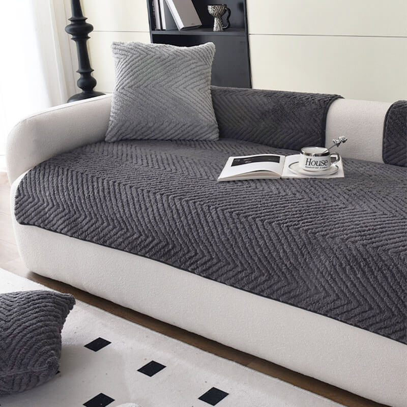 Stylish plush herringbone non-slip sofa cover draped over a couch, enhancing home comfort