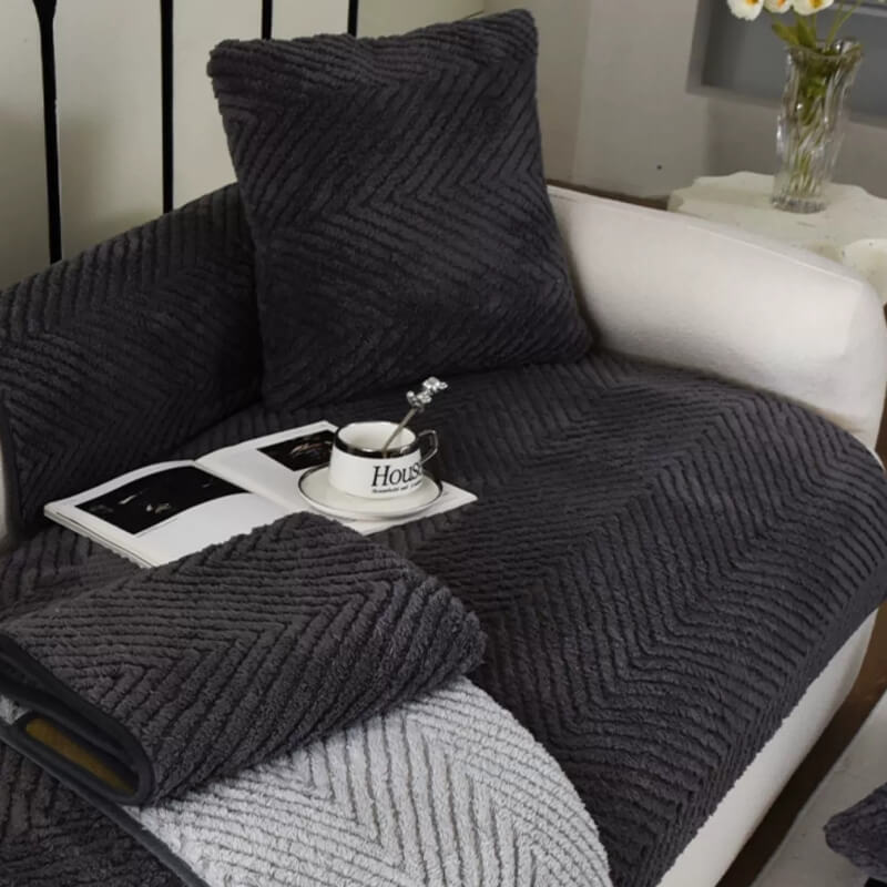 Full view of a living room sofa covered with a plush herringbone non-slip couch cover for comfort
