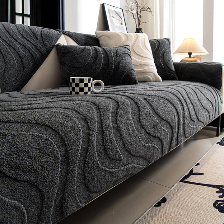 Full view of a plush jacquard non-slip sofa cover draped over a couch.