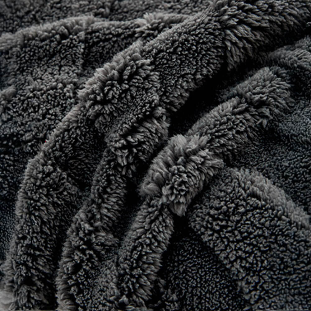 Corner detail of a plush jacquard non-slip couch cover, secure and decorative.