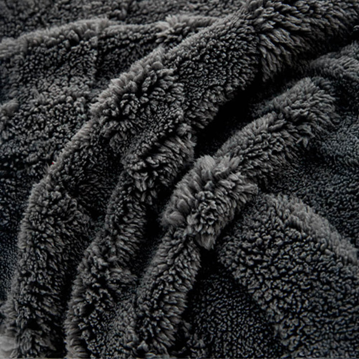 Corner detail of a plush jacquard non-slip couch cover, secure and decorative.