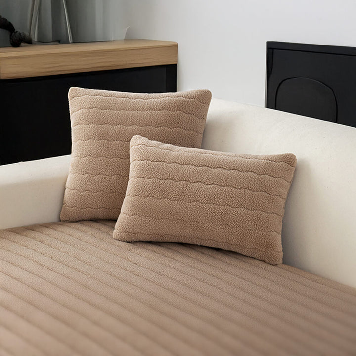 Plush lambskin feel couch cover providing comfort and protection for a family sofa