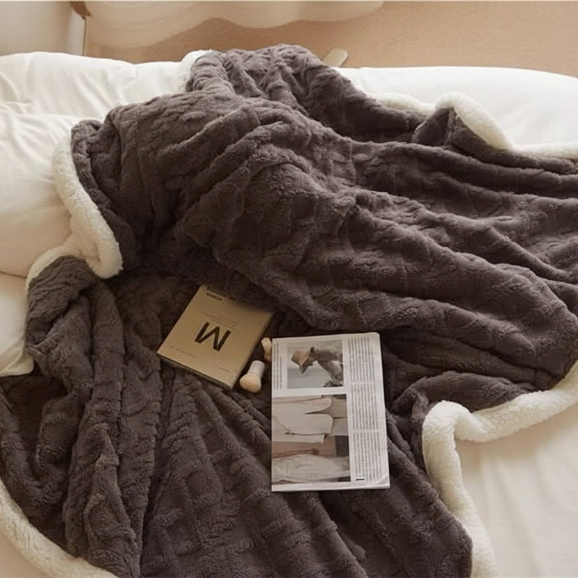 Soft lambswool blanket for cozy home warmth. Plush, reversible throw, perfect for bedroom comfort.