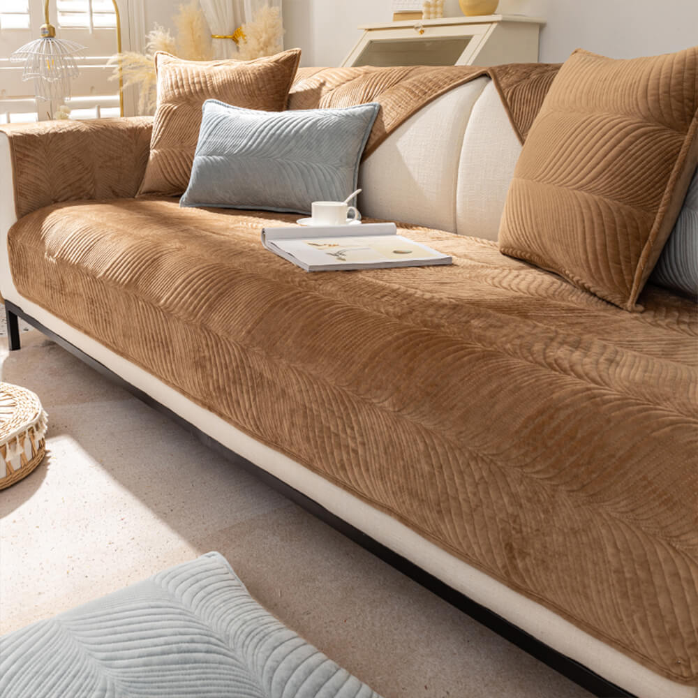 Plush leaf pattern non-slip sofa cover for home decor, protecting furniture and adding warmth.