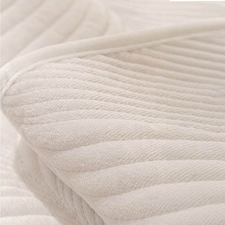 Full view of a non-slip plush couch cover, highlighting its attractive leaf pattern and warmth.