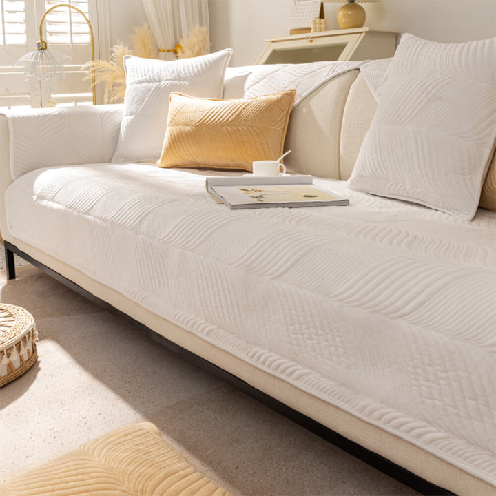 Non-slip couch cover made from plush material, featuring a decorative leaf pattern, easy clean.
