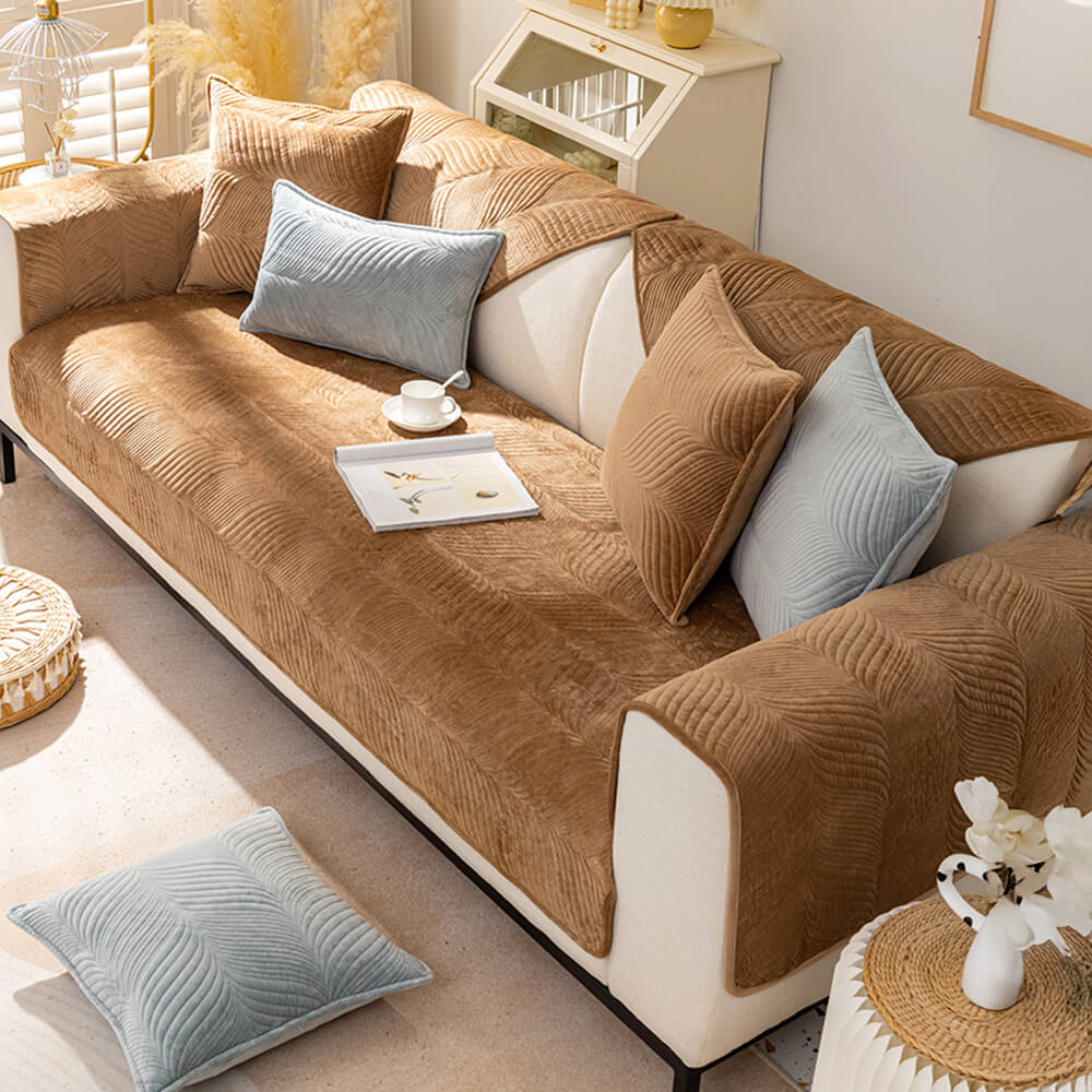 Soft plush couch cover with subtle leaf pattern, designed for non-slip furniture protection.