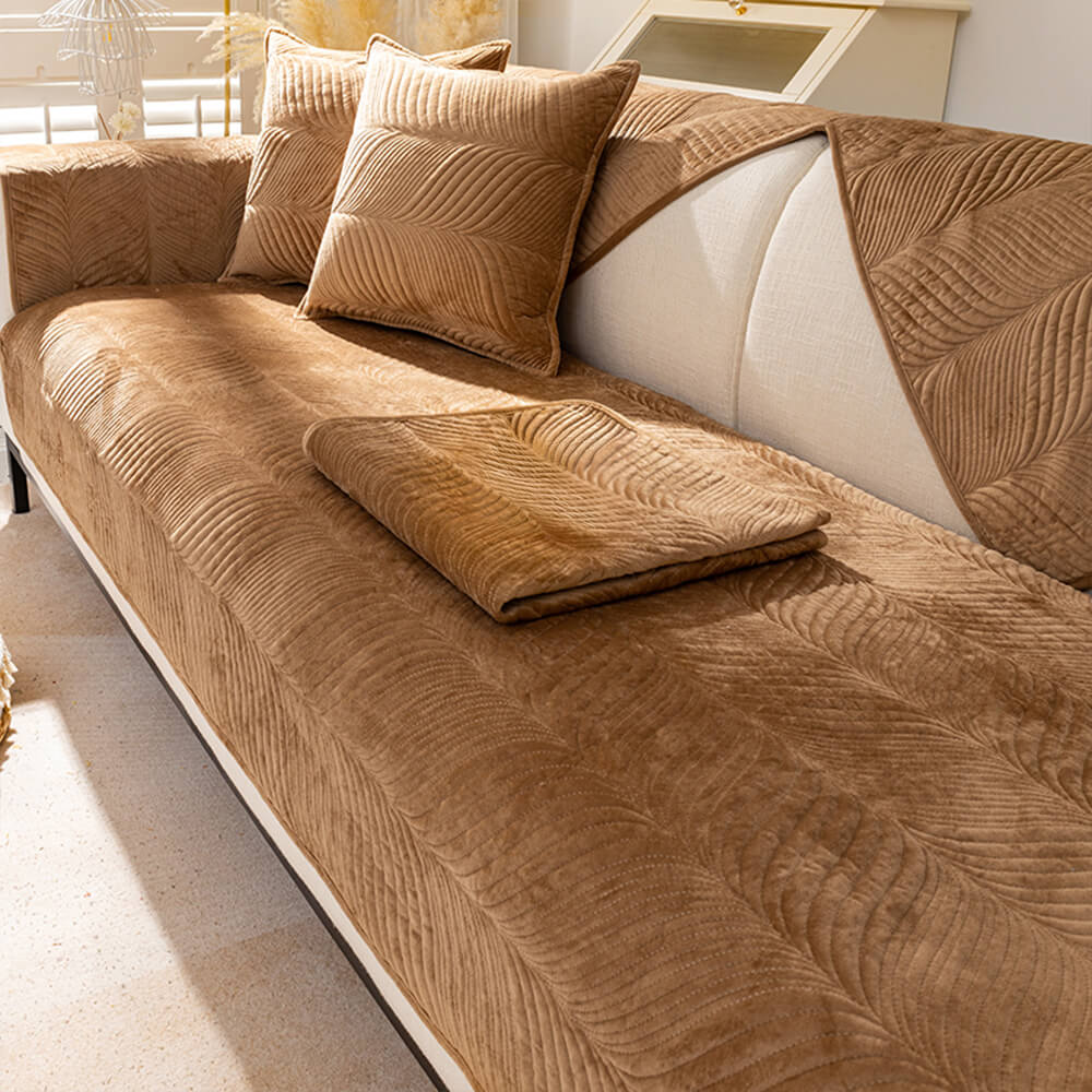 Beige plush sofa cover featuring an elegant leaf pattern, ideal for home decor and comfort.