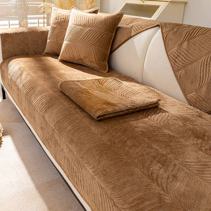 Beige plush sofa cover featuring an elegant leaf pattern, ideal for home decor and comfort.