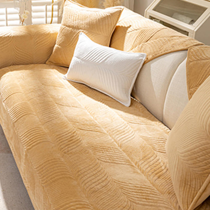 Close-up of a plush non-slip sofa cover showing its intricate leaf pattern and soft texture.