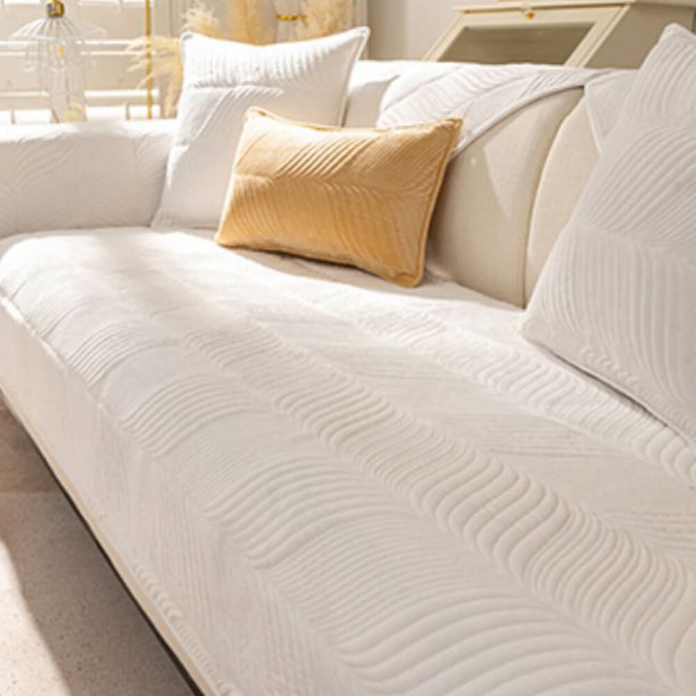 Sectional sofa covered with a plush leaf pattern cover, enhancing home decor and warmth.