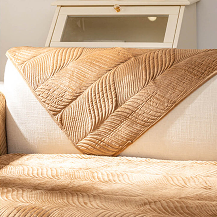 Detailed view of the plush fabric and delicate leaf pattern on a non-slip couch cover.