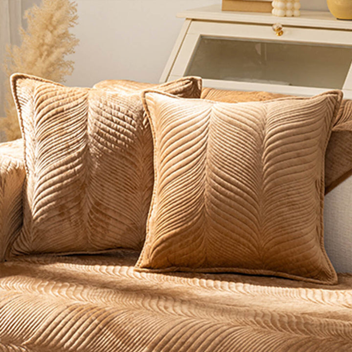 Living room with a sofa adorned by a plush non-slip leaf pattern cover, chic home decor.