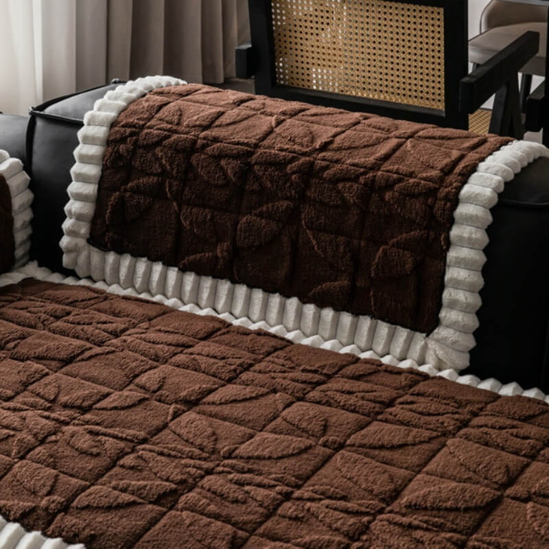 Detail view of the plush texture and subtle leaf pattern on a non-slip sofa cover
