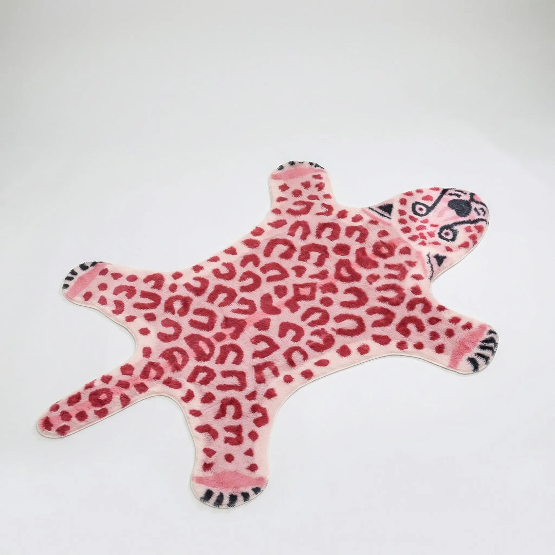 Soft, plush pink leopard print animal shaped rug with wavy edges, adding a wild yet elegant statement to any room.