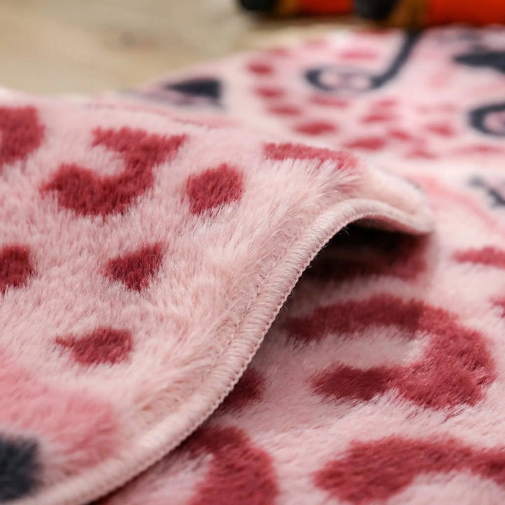Flowique pink leopard print animal accent rug. Plush and uniquely shaped for a playful touch in bedrooms or playrooms.