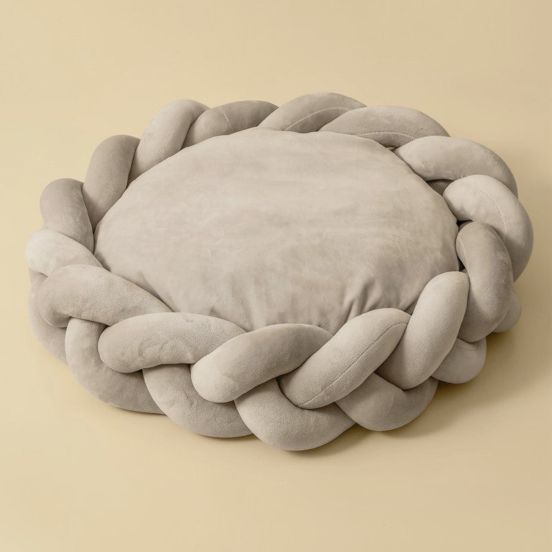Dog sleeping soundly on a plush luxury bolster bed with braided edges, ultimate comfort.
