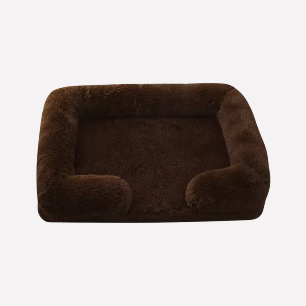 Happy dog resting on a soft non-slip plush pet bed, serene comfort
