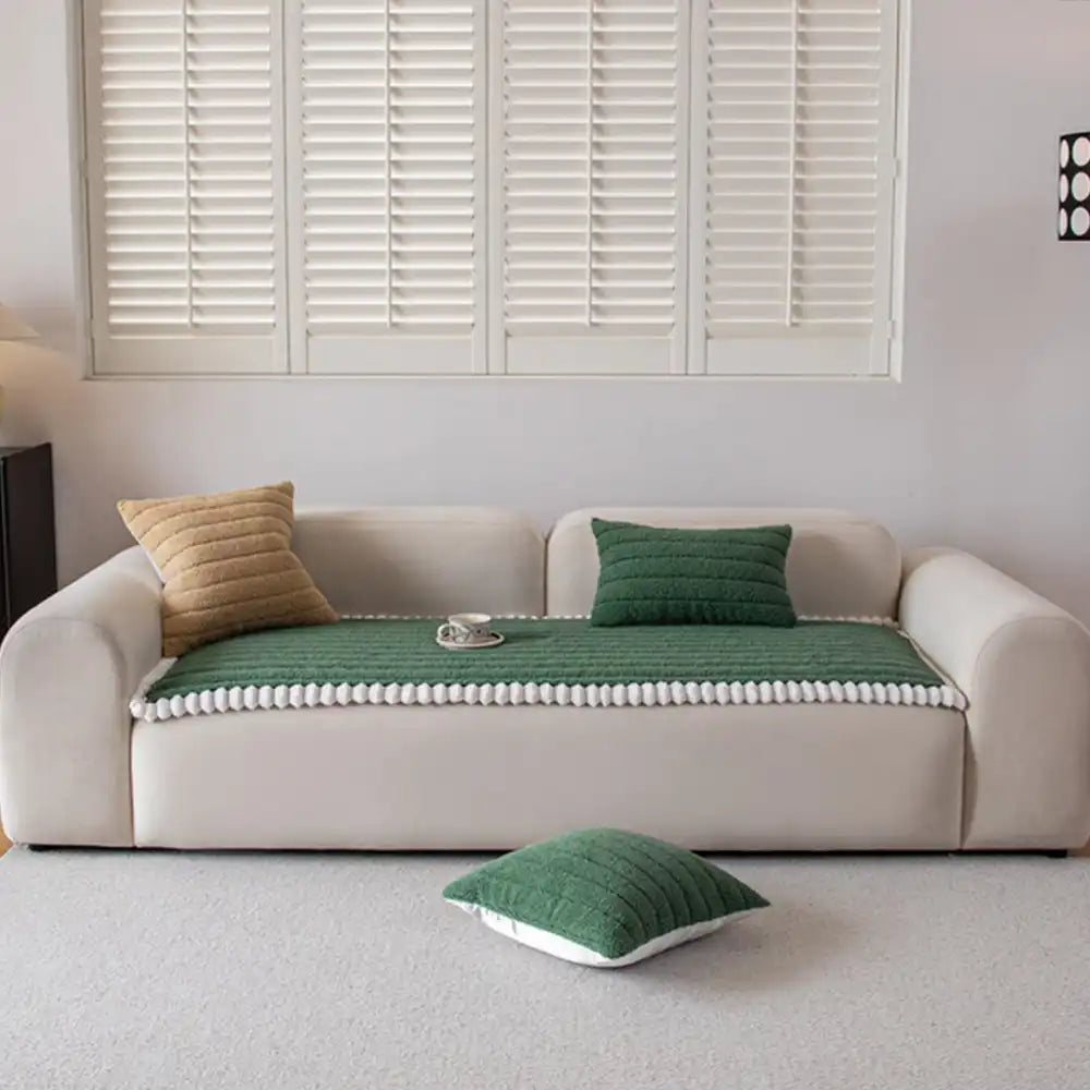 White non-slip sofa cover on a pristine armchair, offering elegant and practical furniture protection.