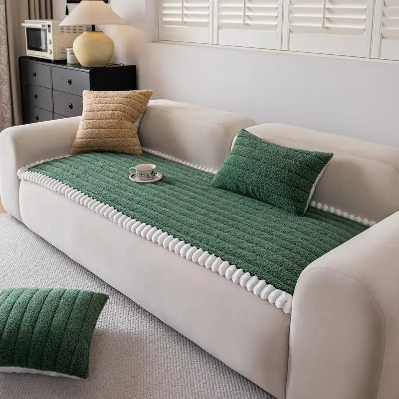 Universal beige non-slip sofa cover draped over a sectional, offering elegant furniture protection.