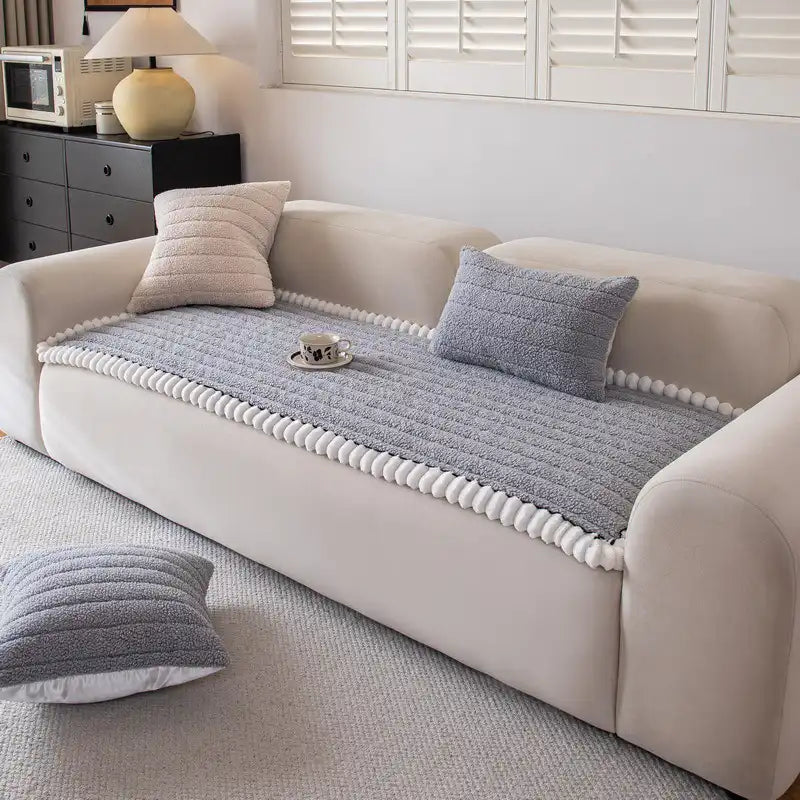 Machine washable dark blue couch cover with a non-slip backing, ideal for homes with pets.
