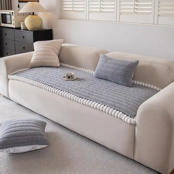Machine washable dark blue couch cover with a non-slip backing, ideal for homes with pets.