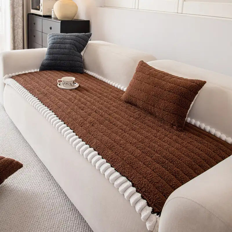 Stylish non-slip sofa cover in a modern geometric pattern, enhancing living room decor.
