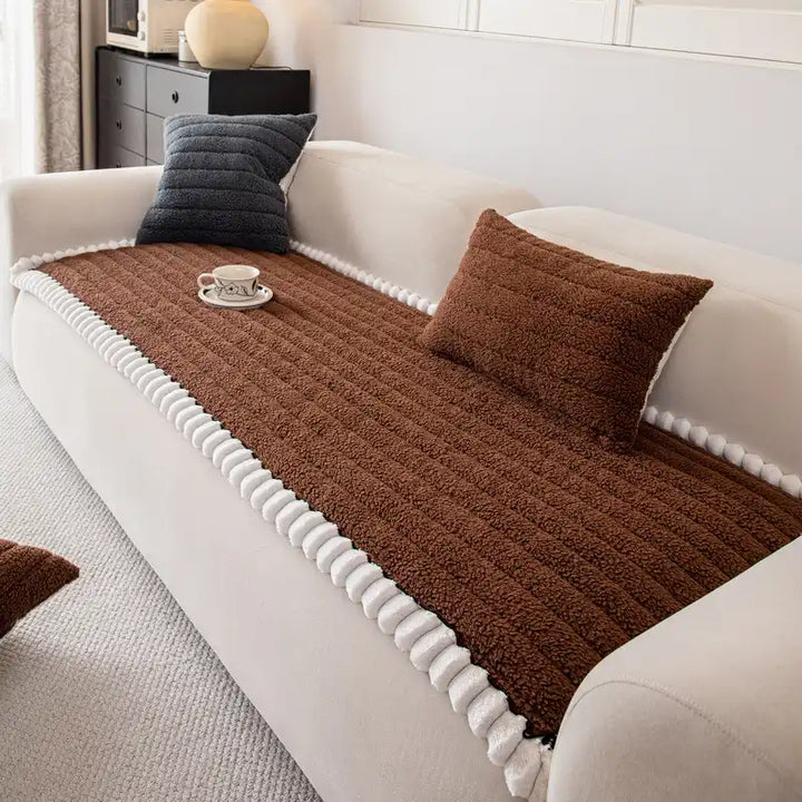 Stylish non-slip sofa cover in a modern geometric pattern, enhancing living room decor.