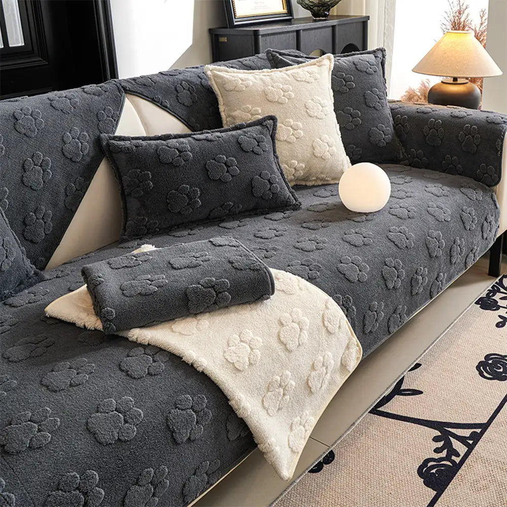 Plush non-slip sofa cover with black paw print design for pet-friendly home decor