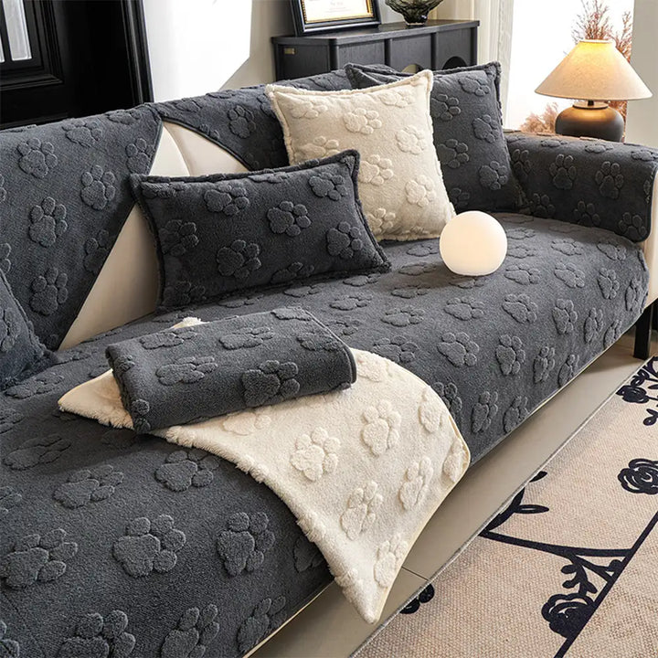 Plush non-slip sofa cover with black paw print design for pet-friendly home decor
