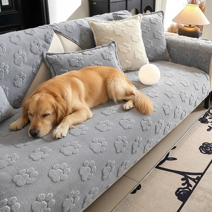 Soft pet-friendly couch cover featuring white paw prints on a dark plush fabric