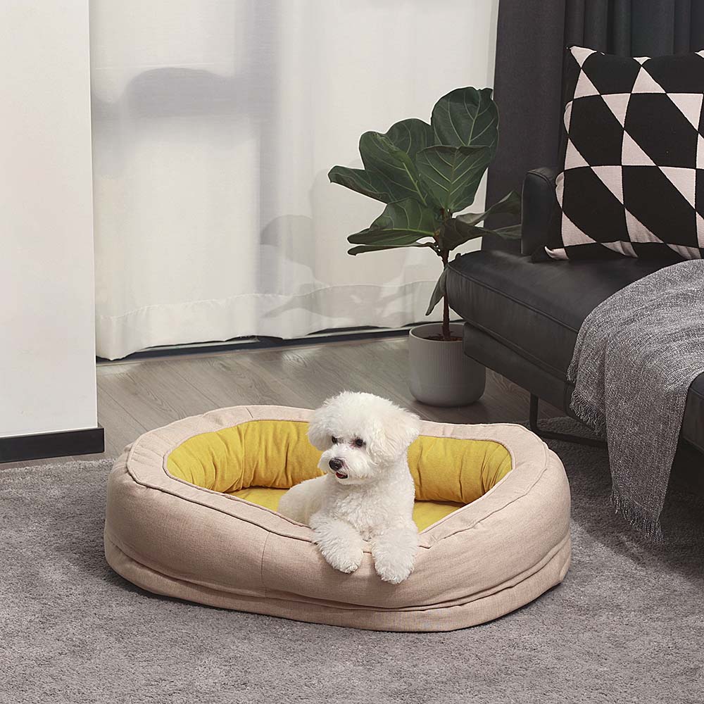 Stylish donut pet bed, fluffy and orthopedic, supporting dog joint health while sleeping.