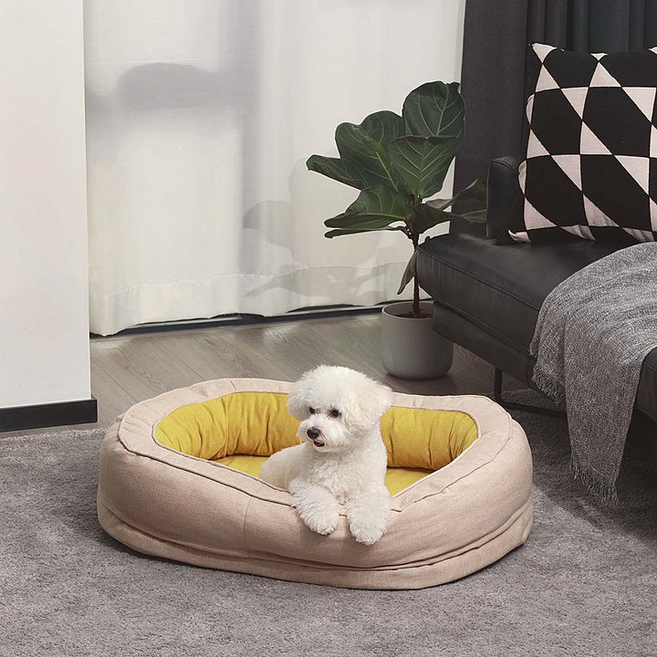 Stylish donut pet bed, fluffy and orthopedic, supporting dog joint health while sleeping.
