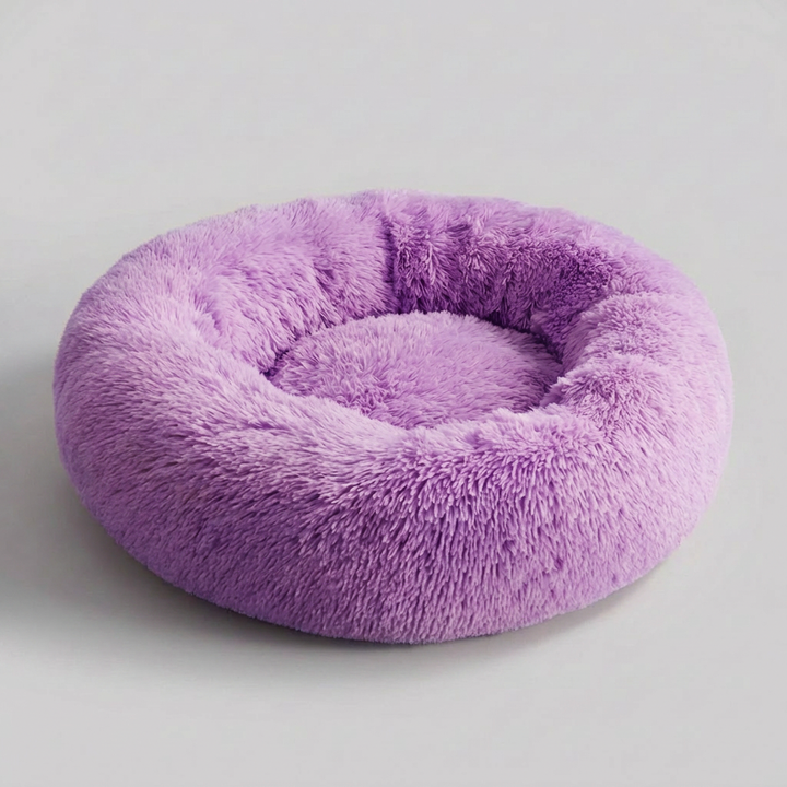 Dog relaxing in a supportive, soft pet bed for anxiety relief, a plush calming nest designed for pet comfort.