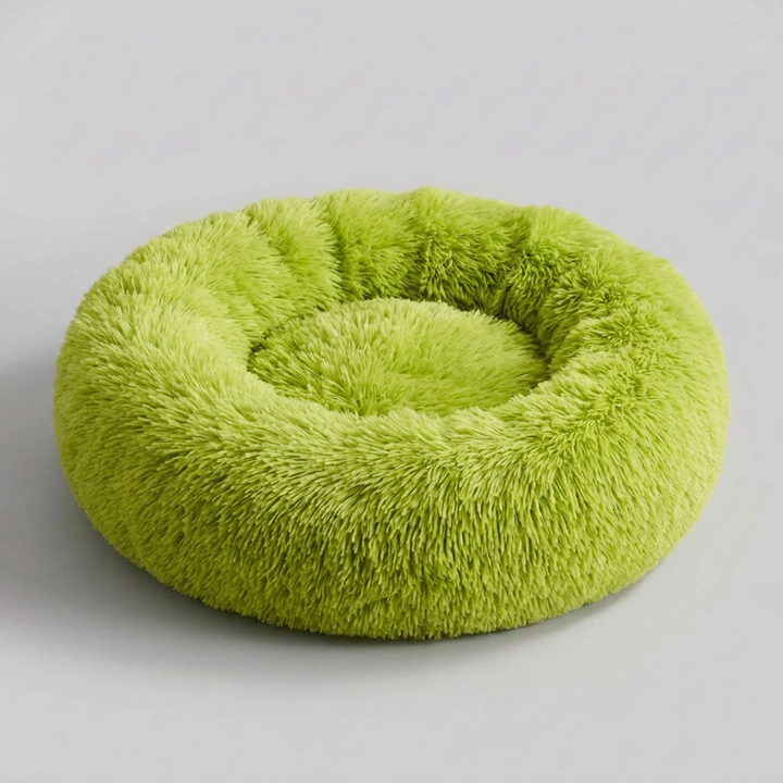 Washable round calming dog bed, plush faux fur pet nest for anxiety relief, durable comfort for dogs.