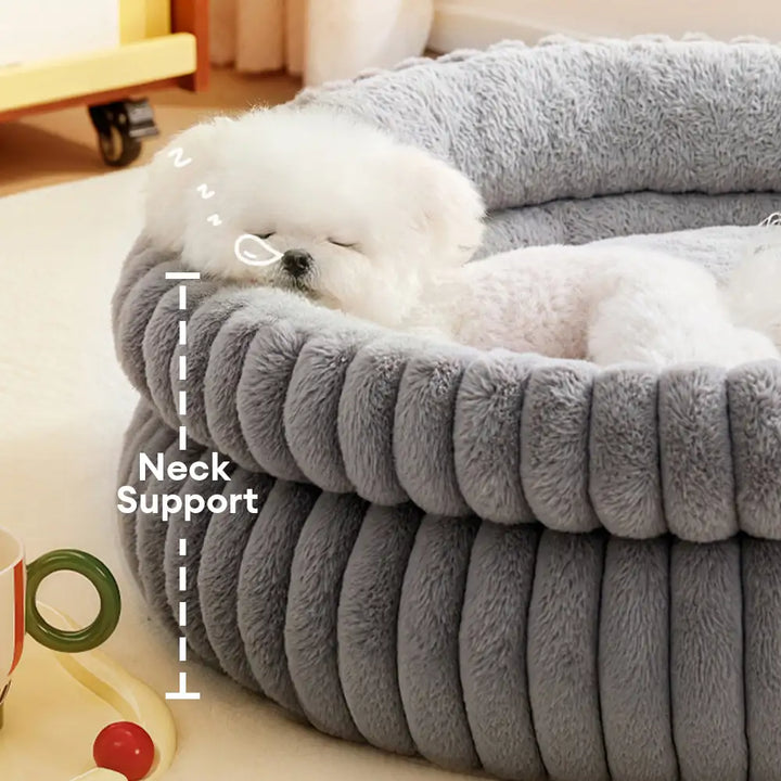Close-up of plush fabric on a cozy cuddler pet bed, showing soft texture and raised sides