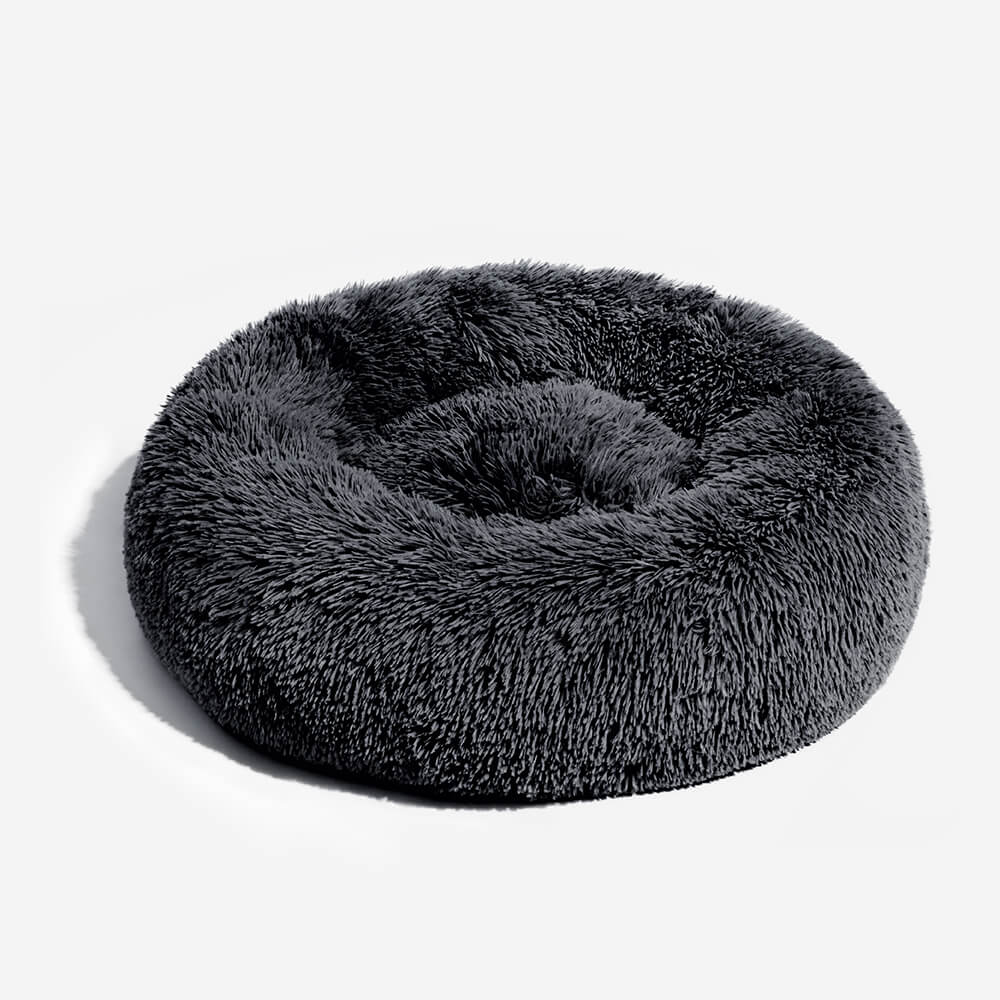 Round plush dog bed, grey, offering warmth and anxiety relief for pets